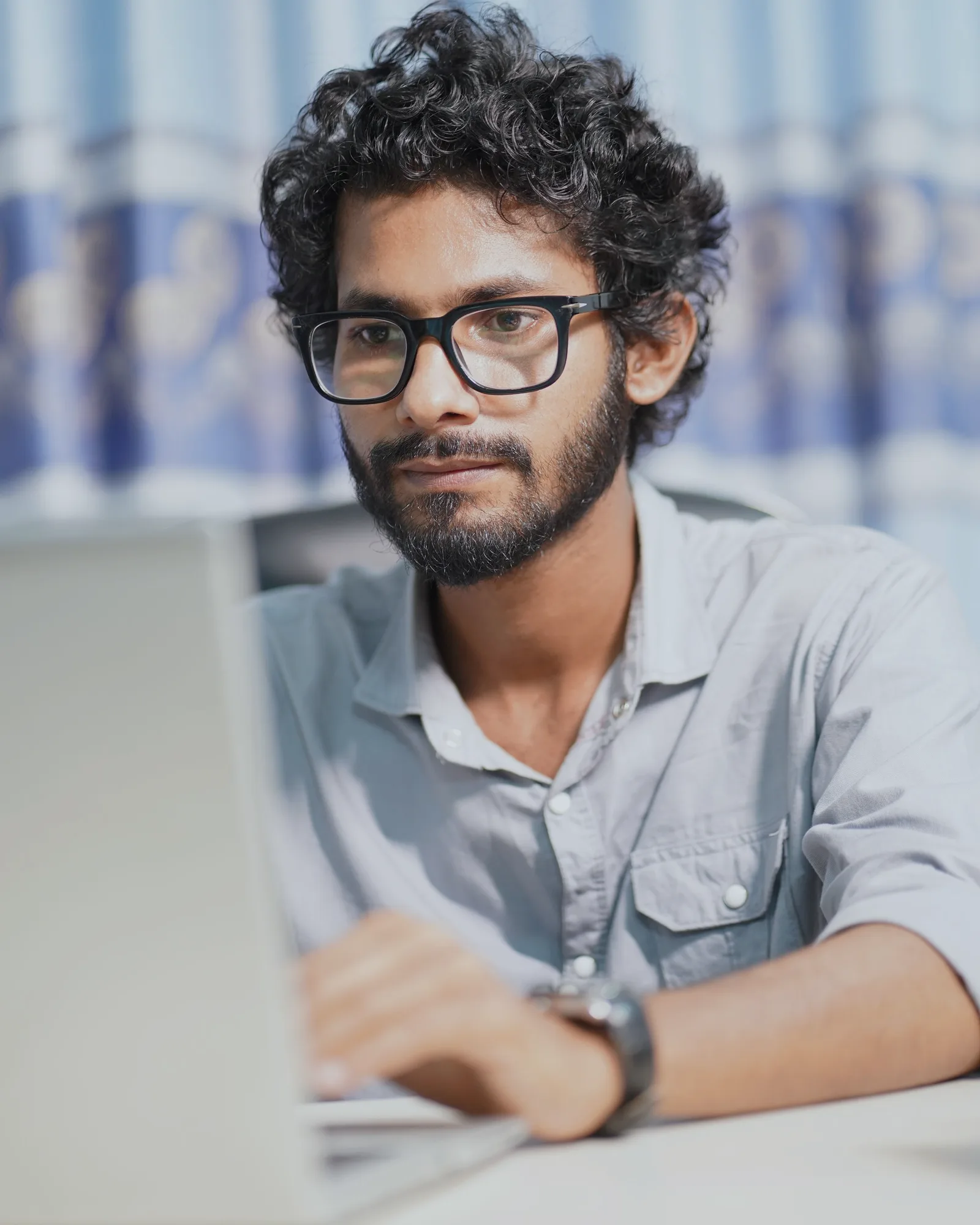 A finance professional working at a laptop, focused on the screen.